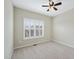 A bright, empty bedroom with carpet and a window with shuttered blinds at 1319 Rodessa Run, Raleigh, NC 27607
