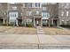 Charming brick townhomes featuring multiple levels, prominent windows, and well-maintained landscaping along the front at 1319 Rodessa Run, Raleigh, NC 27607