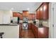 Well-equipped kitchen with stainless steel appliances, granite countertops and dark wood cabinets at 1319 Rodessa Run, Raleigh, NC 27607