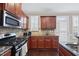 Kitchen with stainless steel appliances, granite countertops, and hardwood floors at 1319 Rodessa Run, Raleigh, NC 27607