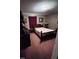 Bedroom featuring a wooden bed frame, paneled walls, and overhead lighting at 16 Marsh Mciver Rd, Bear Creek, NC 27207