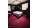 This cozy bedroom features a black paneled wall, two windows, and a ceiling fan at 16 Marsh Mciver Rd, Bear Creek, NC 27207