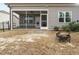 Backyard featuring a screened porch, a fire pit, and comfortable outdoor living at 177 Magenta Rose Dr, Raleigh, NC 27610