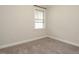 Cozy bedroom with neutral carpet, natural light and a window with white trim, creating a relaxing atmosphere at 177 Magenta Rose Dr, Raleigh, NC 27610