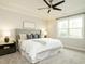 Primary bedroom featuring a tray ceiling, a ceiling fan, a large bed, and lots of natural light at 177 Magenta Rose Dr, Raleigh, NC 27610