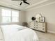 Primary bedroom featuring a tray ceiling, a ceiling fan, a large bed, and lots of natural light at 177 Magenta Rose Dr, Raleigh, NC 27610