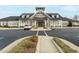 Community clubhouse exterior with elegant stone and siding accents, showcasing well-maintained landscaping at 177 Magenta Rose Dr, Raleigh, NC 27610