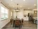 Cozy dining area featuring a modern chandelier and hardwood floors, perfect for intimate gatherings at 177 Magenta Rose Dr, Raleigh, NC 27610