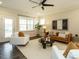 Bright and airy living room featuring modern furniture, neutral tones, and a ceiling fan for comfortable living at 177 Magenta Rose Dr, Raleigh, NC 27610
