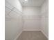 Spacious walk-in closet featuring ample shelving and neutral carpet, providing plenty of storage space at 177 Magenta Rose Dr, Raleigh, NC 27610
