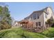 Fenced backyard with a large deck and mature trees at 2006 Mill Gate Ln, Cary, NC 27519