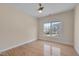 Bedroom featuring hardwood floors, a ceiling fan, and a large window overlooking yard at 2006 Mill Gate Ln, Cary, NC 27519