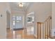 Elegant foyer with hardwood floors, chandelier, and a view into the living spaces at 2006 Mill Gate Ln, Cary, NC 27519