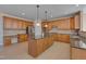 Large kitchen with granite countertops, central island, stainless appliances, and custom cabinets and tile backsplash at 2006 Mill Gate Ln, Cary, NC 27519