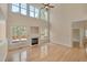 Bright living room with a fireplace, hardwood floors, and large windows overlooking the backyard deck at 2006 Mill Gate Ln, Cary, NC 27519