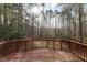Wood deck with railings overlooking a yard of tall thin trees providing plenty of shade at 202 River Hills Dr, Clayton, NC 27527