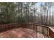 Wood deck and railing provide great outdoor views of the surrounding natural wooded landscape at 202 River Hills Dr, Clayton, NC 27527