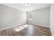 Bedroom featuring wood-look floors, neutral paint, and natural light at 202 River Hills Dr, Clayton, NC 27527
