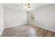 Bedroom featuring wood-look floors, neutral paint, window, and ceiling fan at 202 River Hills Dr, Clayton, NC 27527