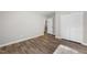 Bedroom featuring wood-look floors, neutral paint, and closet at 202 River Hills Dr, Clayton, NC 27527