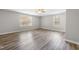 Bedroom featuring wood-look floors, neutral paint, and lots of natural light at 202 River Hills Dr, Clayton, NC 27527