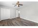 Spacious bedroom with wood-look floors, ceiling fan, closet, and neutral paint at 202 River Hills Dr, Clayton, NC 27527