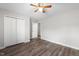 Bedroom features wood-look floors, neutral paint, ceiling fan, and closet at 202 River Hills Dr, Clayton, NC 27527