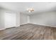 Bedroom features wood-look floors, neutral paint, closet, and ceiling fan at 202 River Hills Dr, Clayton, NC 27527