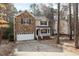 Charming two-story home with a stone facade and inviting front porch at 202 River Hills Dr, Clayton, NC 27527
