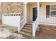Close up of the front entrance with a charming brick porch and white railings at 202 River Hills Dr, Clayton, NC 27527