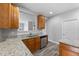 Updated kitchen features wooden cabinets, granite countertops, stainless steel appliances, and wood flooring at 202 River Hills Dr, Clayton, NC 27527