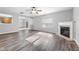 Inviting living room with a fireplace, modern flooring, and a view into the kitchen at 202 River Hills Dr, Clayton, NC 27527