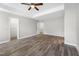 Bright main bedroom featuring wood flooring, a ceiling fan, and a tray ceiling at 202 River Hills Dr, Clayton, NC 27527