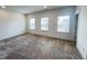 Spacious bedroom with plush carpeting, three large windows, and neutral walls at 208 Acorn Crossing Rd, Holly Springs, NC 27540