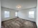 A simple, clean bedroom with carpet and ample natural light streaming through the window at 208 Acorn Crossing Rd, Holly Springs, NC 27540