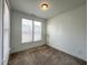 This inviting bedroom offers natural light with neutral walls, carpet, and large windows at 208 Acorn Crossing Rd, Holly Springs, NC 27540