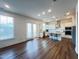 A bright, open kitchen featuring stainless steel appliances, a center island, and hardwood floors at 208 Acorn Crossing Rd, Holly Springs, NC 27540