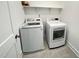 Convenient laundry room with modern washer and dryer, tile flooring, and built-in shelves at 208 Acorn Crossing Rd, Holly Springs, NC 27540