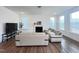 A cozy living room with a fireplace, hardwood floors, and comfortable seating for the Gathering at 208 Acorn Crossing Rd, Holly Springs, NC 27540