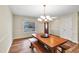 Bright dining room with hardwood floors, modern chandelier and door to the exterior at 209 Falcon Ct, Clayton, NC 27520