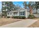 Charming ranch-style home features brick foundation, light-green siding, dark roof, and a long driveway at 209 Falcon Ct, Clayton, NC 27520