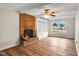 Light-filled living room features fireplace, built-in shelving, and wood-look floors at 209 Falcon Ct, Clayton, NC 27520