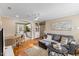 Open-concept living room featuring hardwood floors, a gray sofa, and seamless flow to the kitchen at 2209 Bernard St, Raleigh, NC 27608