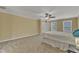 Large bedroom featuring two windows, plush carpet, ceiling fan, and neutral-colored walls at 2224 Cedar Grove Dr, Durham, NC 27703