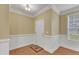 Bright foyer with hardwood floors, white trim, and a view of a front-facing window, creating a welcoming entrance at 2224 Cedar Grove Dr, Durham, NC 27703