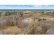 Expansive aerial view showcasing the house, surrounded by lush trees and open fields at 2418 Crossroads Ave, Hillsborough, NC 27278