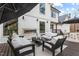 Relaxing deck area with an outdoor fireplace, lounge seating, and dining area at 2418 Crossroads Ave, Hillsborough, NC 27278