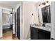 Well-lit bathroom with a granite countertop vanity and a view to the bedroom at 2418 Crossroads Ave, Hillsborough, NC 27278