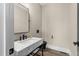 Powder room features a marble vanity, black fixtures, and modern lighting at 2418 Crossroads Ave, Hillsborough, NC 27278