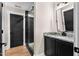 Stylish bathroom featuring granite countertops and a glass enclosed shower with a black frame at 2418 Crossroads Ave, Hillsborough, NC 27278